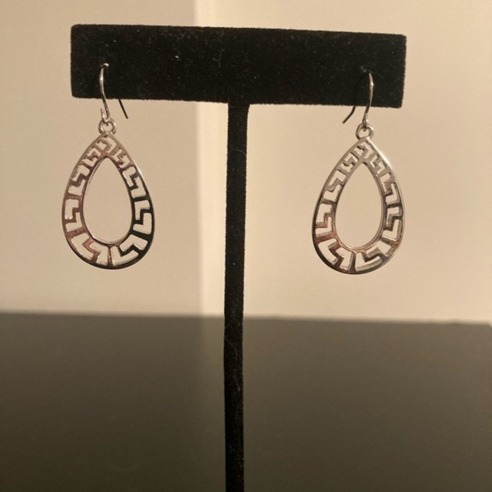 Christopher and Banks silver tone earring. Geometric cut outs in tear drop shape
